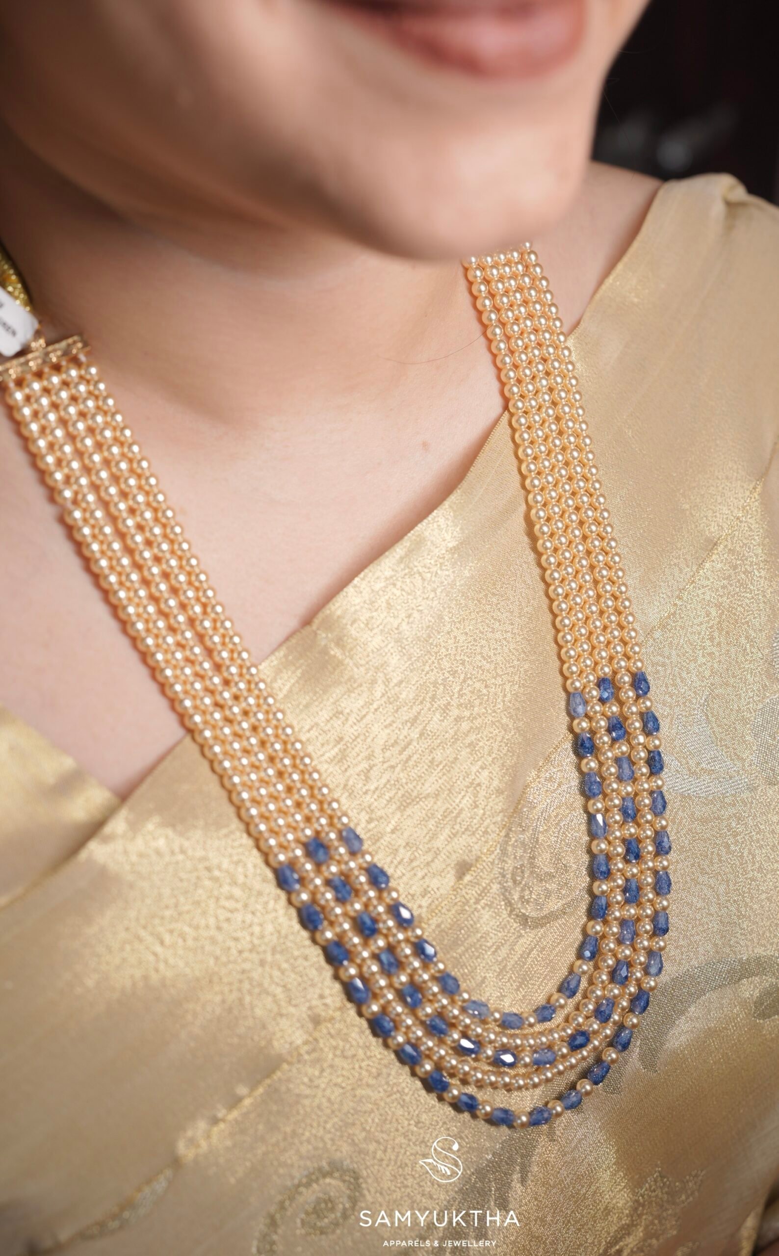 The layered multi-strand pearl and sapphire necklace